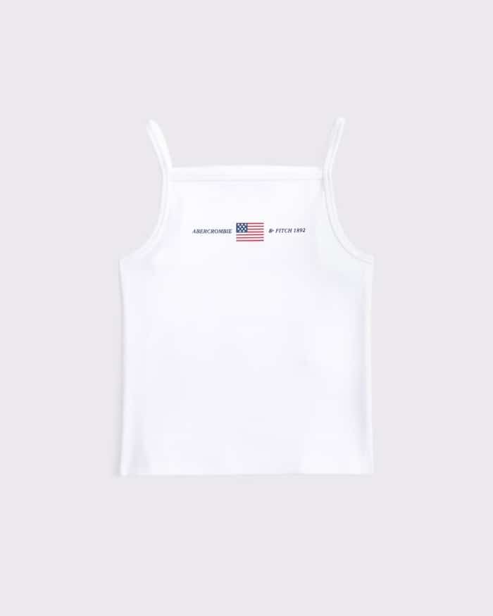 A white spaghetti strap tank top featuring a small American flag and the text ABERCROMBIE & FITCH 1892 printed near the neckline—perfect July fashion for your 4th of July style guide.