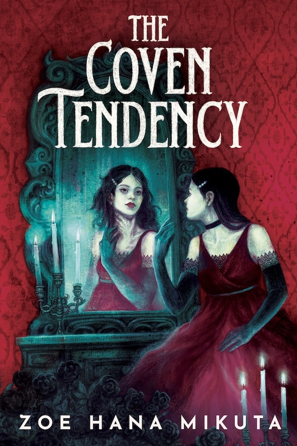 A woman in a red dress and black gloves sits before an ornate mirror, gazing at her own eerie reflection. Candles burn on the vanity, casting a blue-green glow—an unexpected pick among summer reads. The Coven Tendency by Zoe Hana Mikuta appears above and below.