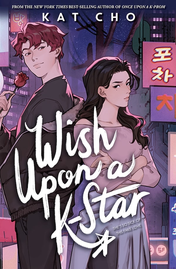 Illustrated book cover showing a young man with red hair eating street food and a serious young woman with long dark hair, set against neon-lit Korean signs—a perfect summer read to toss in your beach tote. The title reads Wish Upon a K-Star.