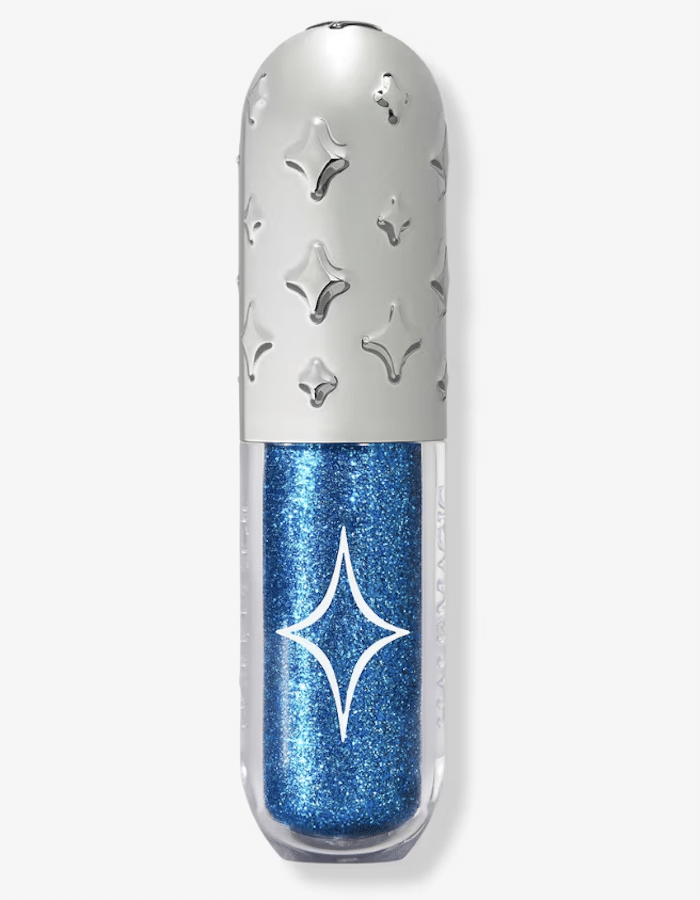 A tube of blue glittery liquid eyeshadow from the brights collection, with a silver cap decorated with raised star shapes and a star symbol on the clear container.