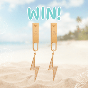 A pair of gold lightning bolt earrings stand upright in sandy beach foreground, with a blurred ocean and sky background. The word WIN! appears above the earrings, celebrating win jewelry. White shell illustrations decorate the image.
