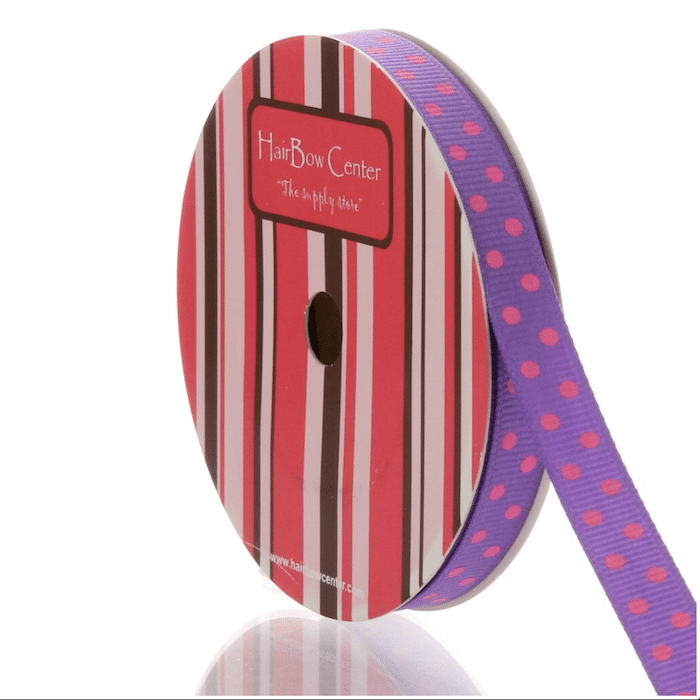 A spool of purple ribbon with pink polka dots, perfect for summer hair accessory projects, labeled HairBow Center and set against a red, pink, brown, and white striped packaging background.