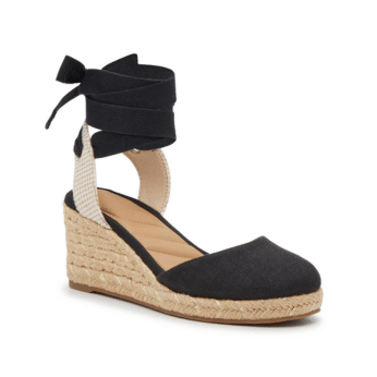 A black espadrille wedge shoe with a closed toe, jute-wrapped sole, and black ankle ties that wrap in a bow—perfect for summer fashion outfits inspired by The Summer I Turned Pretty.