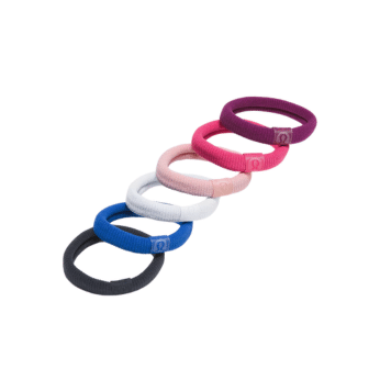 Six fabric hair ties in black, blue, white, pink, red, and purple—perfect for recreating stylish outfits inspired by The Summer I Turned Pretty. Each is arranged in a curved line with a small logo label on a white background.