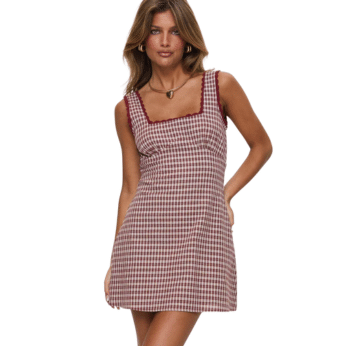 A woman wearing a sleeveless, square-neck, red and white checkered mini dress with red trim, posing with one hand in her pocket against a white background—perfect summer outfit inspiration for fans of cute summer looks.